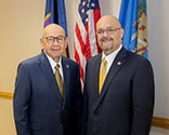 Two men pose for a photo.