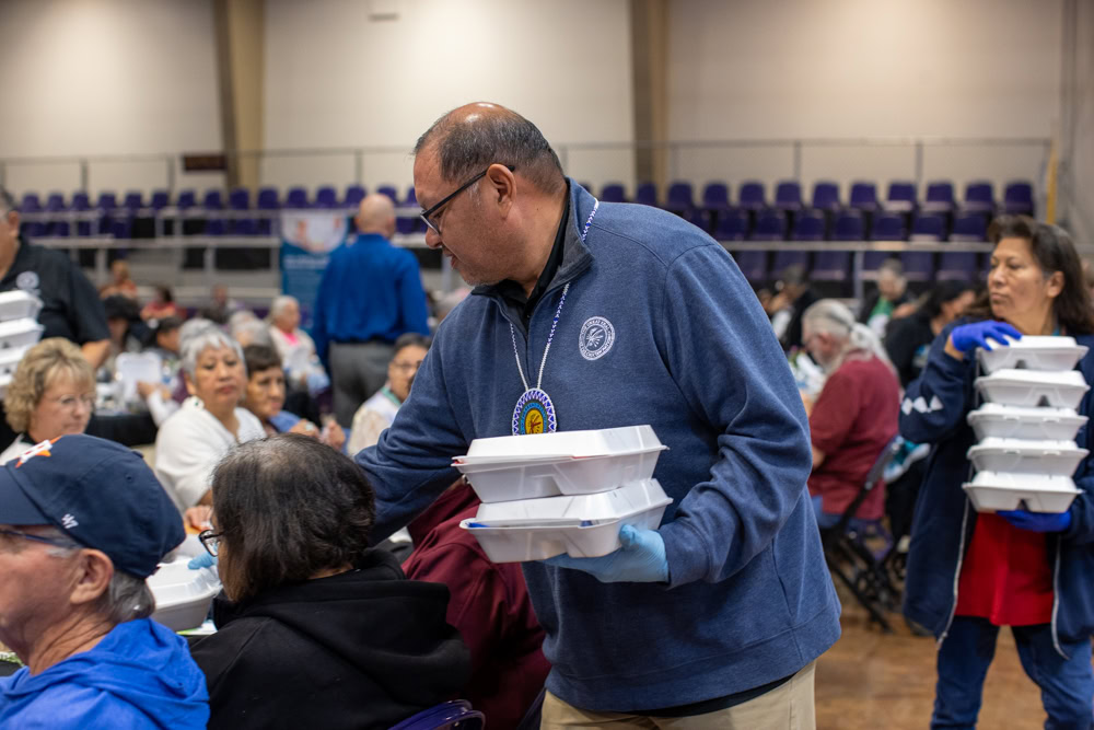 A man passes out meals.