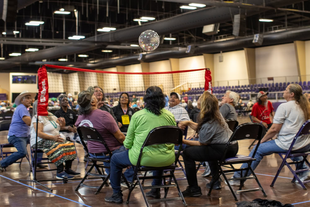 Elders play chair volleyball.