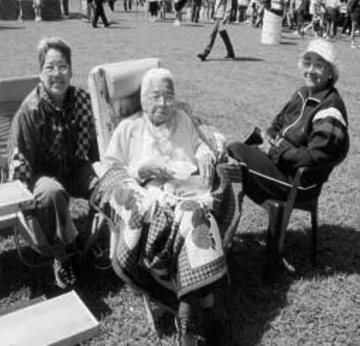 Three people pose for a photo.