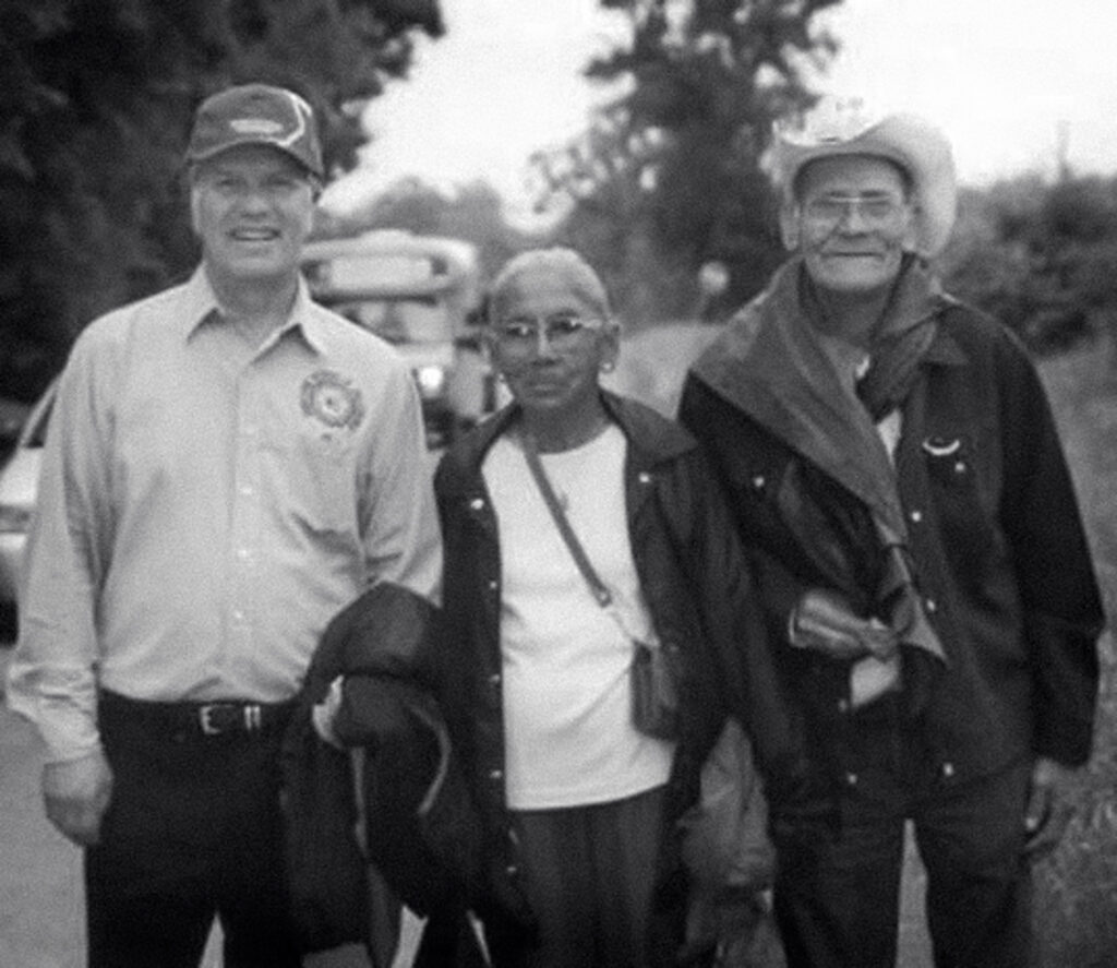 Three people pose for a photo.