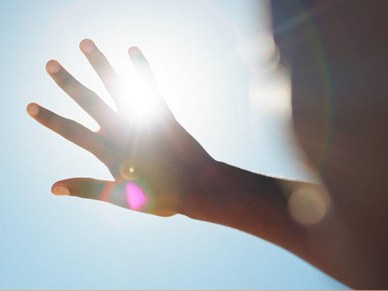 A hand blocks the suns rays