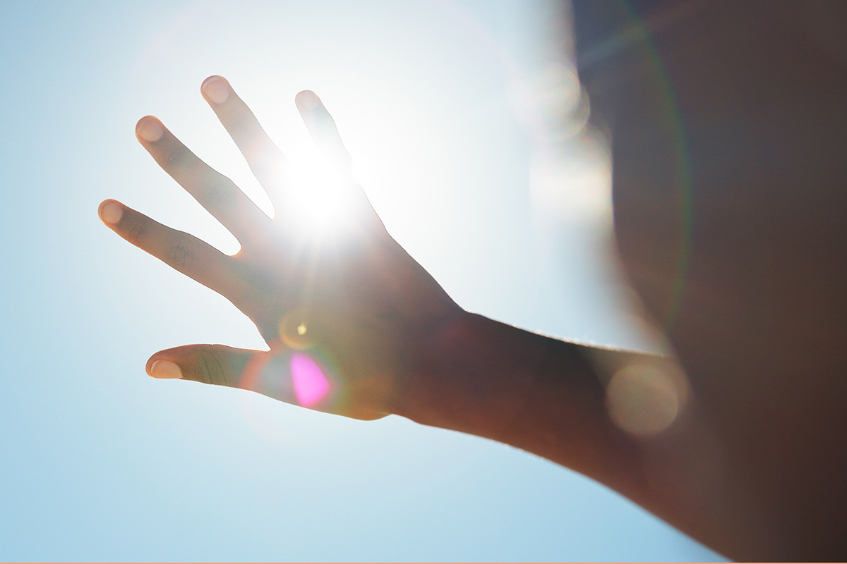 A hand blocks the suns rays