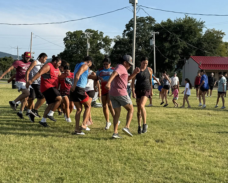 People social dancing on the stickball field.