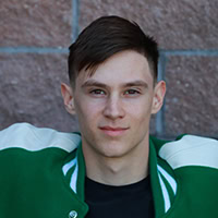 A young man poses for a photo.