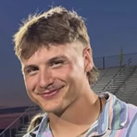 A young man poses for a photo.