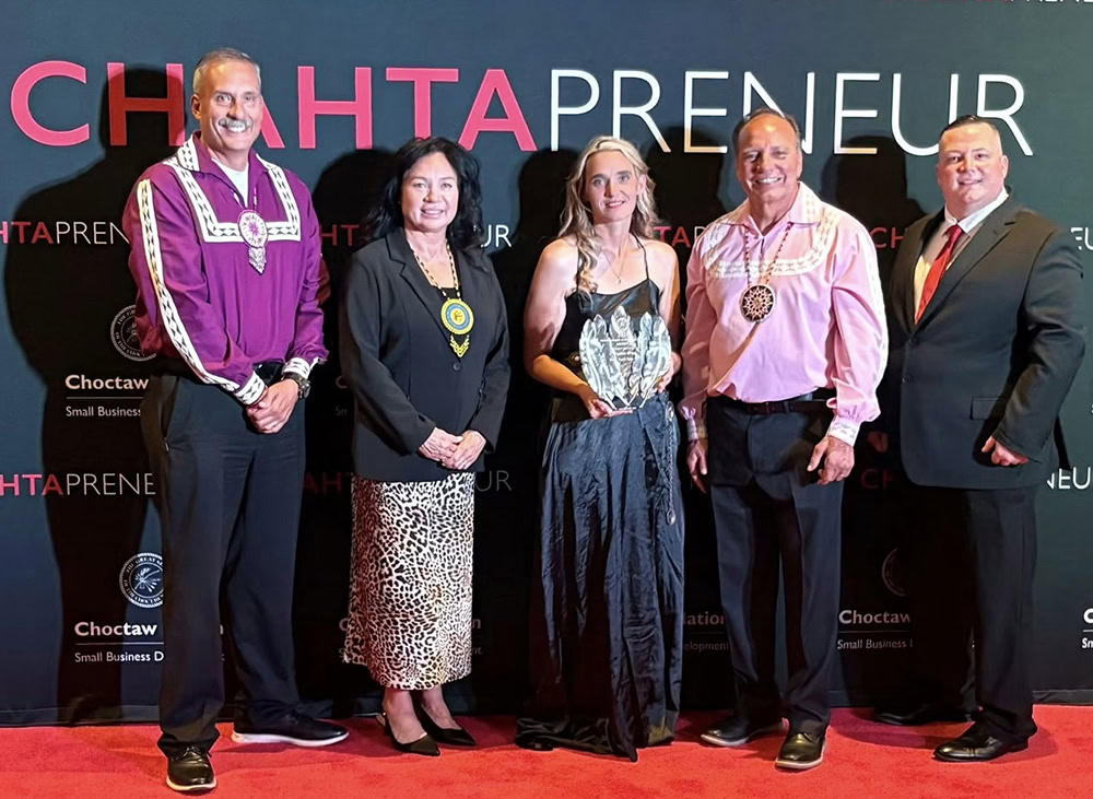 Choctaw Nation leadership and an award winner pose for a photo.
