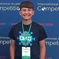 A young man smiles for the camera.