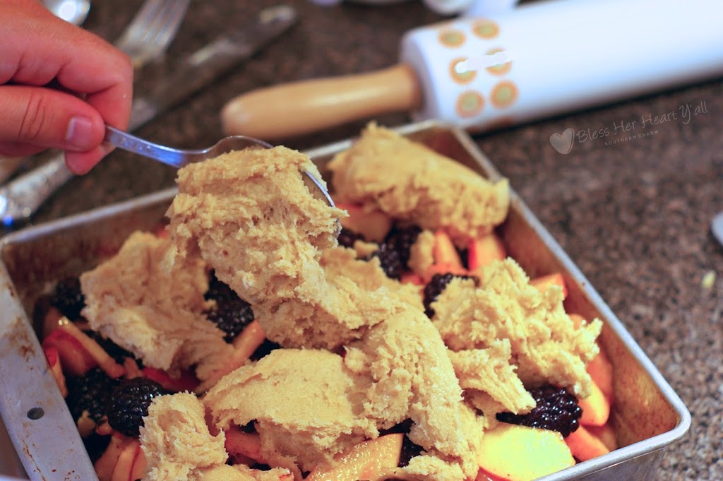 cobbler dough on top of blackberries