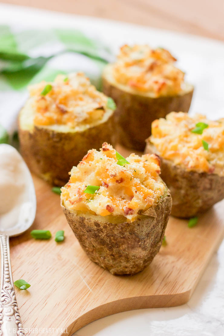 These gluten-free greek yogurt twice baked potatoes are perfectly portioned baked potatoes that are then loaded with healthy creamy greek yogurt, bacon crumbles, spices, and cheese and then baked a second time until the tops are golden brown and crunchy.