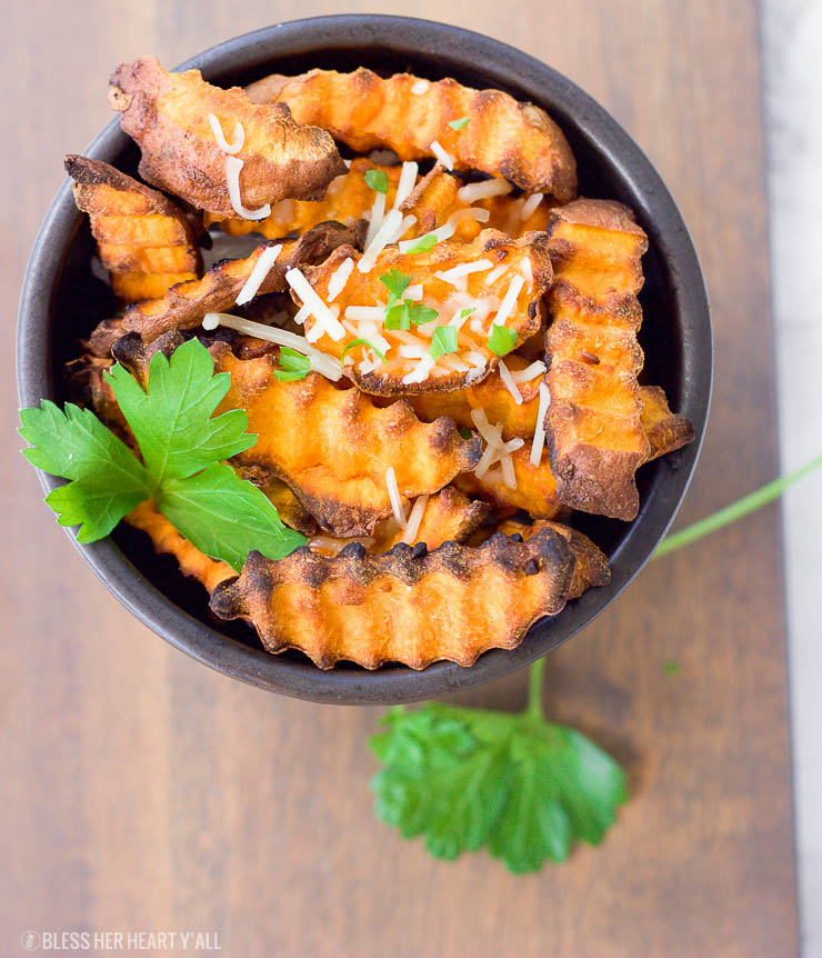 These baked parmesan sweet potato fries are amazingly easy to make with simple ingredients. The hints of savory garlic and parmesan blend perfectly with the sweetness of the sweet potato pieces!