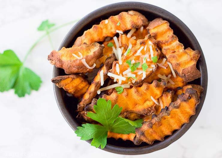 These baked parmesan sweet potato fries are amazingly easy to make with simple ingredients. The hints of savory garlic and parmesan blend perfectly with the sweetness of the sweet potato pieces!