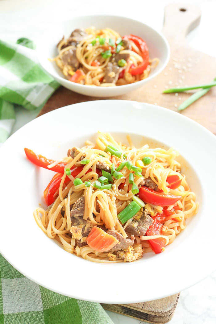 beef pad thai in white serving bowls