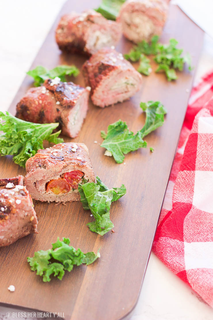 These grilled spicy steak pinwheels use a mixture of cotija cheese, grape tomatoes, pepper flakes, and arugula leaves all wrapped up in some yummy thinly-sliced steak. The drooling starts now! www.BlessHerHeartYall.com