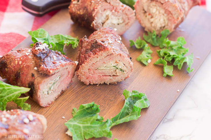 These grilled spicy steak pinwheels use a mixture of cotija cheese, grape tomatoes, pepper flakes, and arugula leaves all wrapped up in some yummy thinly-sliced steak. The drooling starts now! www.BlessHerHeartYall.com