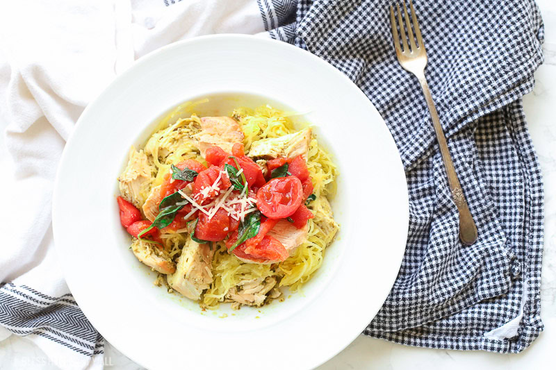 This spinach tomato spaghetti squash recipe combines fresh fluffy spaghetti squash and tops it with an easy and quick spinach and tomato sauce that's so garlicky and savory, the perfect combination of a healthy tasty meal!