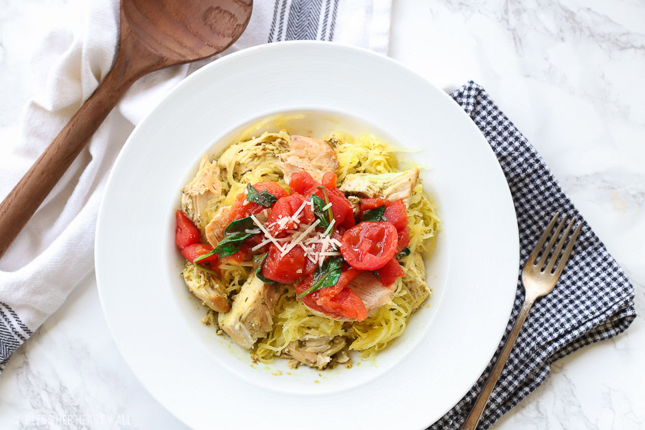 This spinach tomato spaghetti squash recipe combines fresh fluffy spaghetti squash and tops it with an easy and quick spinach and tomato sauce that's so garlicky and savory, the perfect combination of a healthy tasty meal!