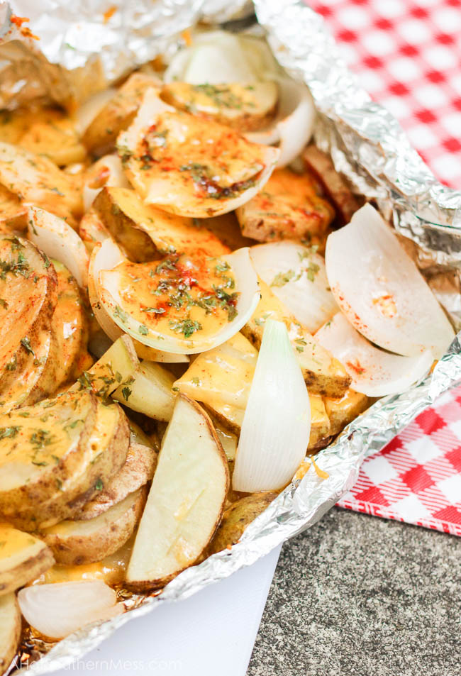 Ooey gooey melty cheesy with no strings attached {as in no dirty dishes to clean!}. What else do I gotta say? {She drops her mic, brushes her hands off, turns around and walks away}. These simple and tasty potato slices are tossed in a layer of cheeses and sweet onion, sprinkled in paprika, parsley, and some “heat”, loaded onto some tin foil and kissed on the grill till tender, crispy on the outside, and melty everywhere else. If stringy melty cheese gets to your heart, you will fall in love with these easy sizzlin’ campfire taters. www.ahotsouthernmess.com