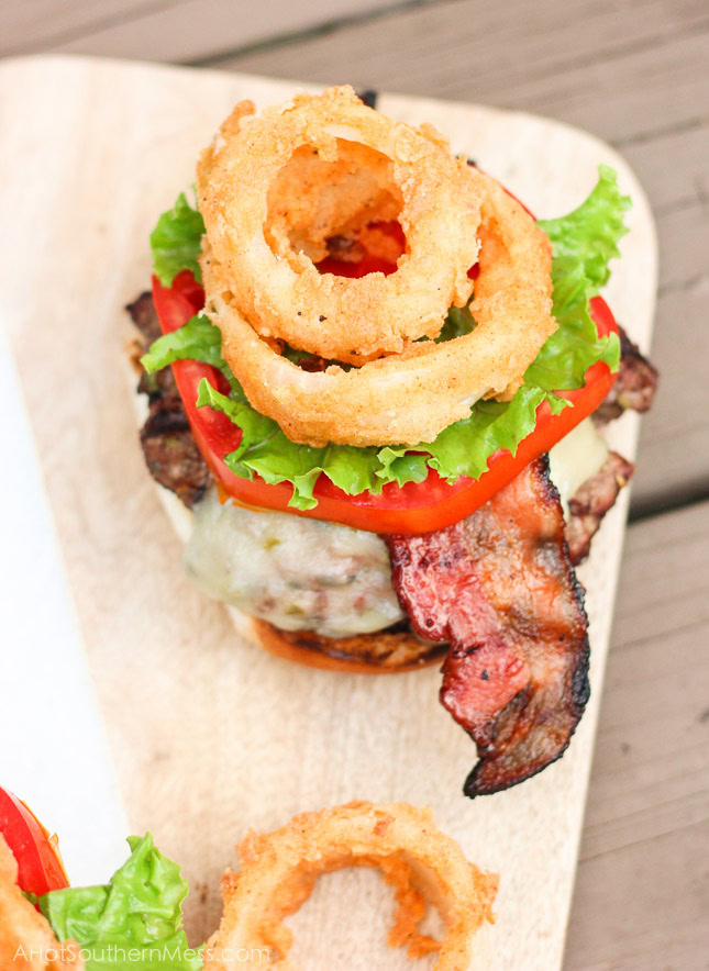 Oh my gosh, this burger looks so good! I have got to try it! Ooey gooey pepper jack cheese is stuffed inside juicy ground beef patties along with fresh bites of crisp spicy jalapeños. The burgers are kissed on the grill long enough to cook to your liking and then stacked on top of a fluffy bun, and then loaded with fresh crisp slices of lettuce and tomato, BBQ bacon, and homemade buttermilk onion rings. www.ahotsouthernmess.com