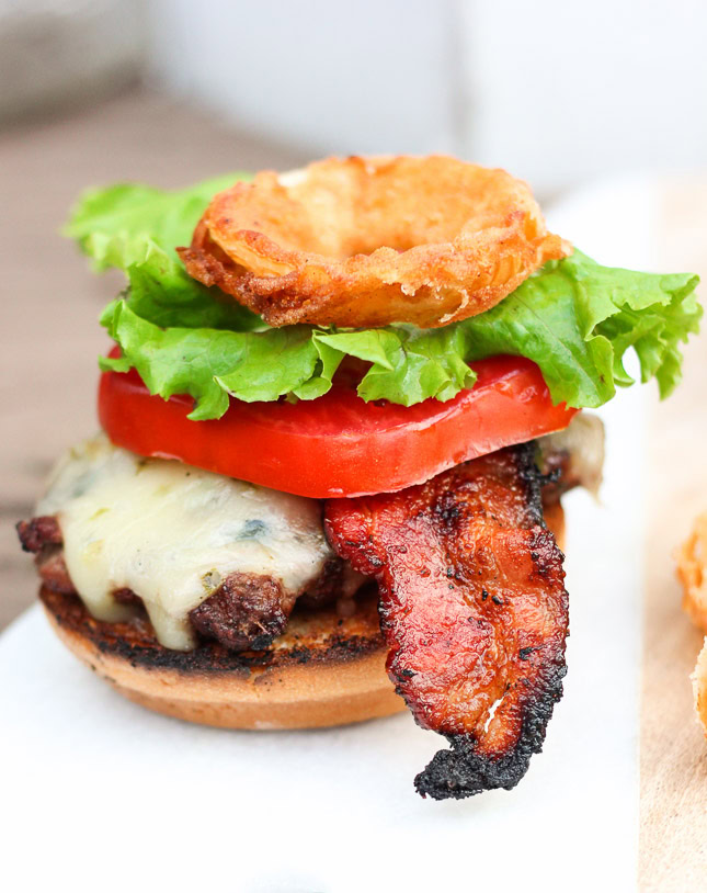 Oh my gosh, this burger looks so good! I have got to try it! Ooey gooey pepper jack cheese is stuffed inside juicy ground beef patties along with fresh bites of crisp spicy jalapeños. The burgers are kissed on the grill long enough to cook to your liking and then stacked on top of a fluffy bun, and then loaded with fresh crisp slices of lettuce and tomato, BBQ bacon, and homemade buttermilk onion rings. www.ahotsouthernmess.com