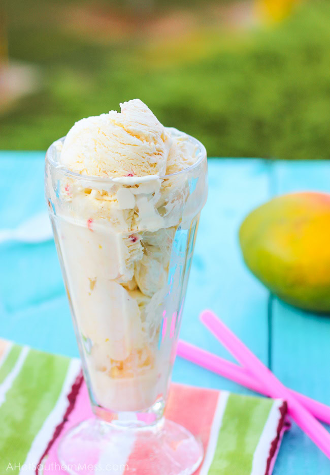 Fresh creamy strawberry mango ice cream with hand picked strawberry pieces and puréed mango folded in. Ten minutes of prep work and just a hand mixer is all that you need to prepare this light, sweet, refreshing treat for those long dog days of summer! www.ahotsouthernmess.com