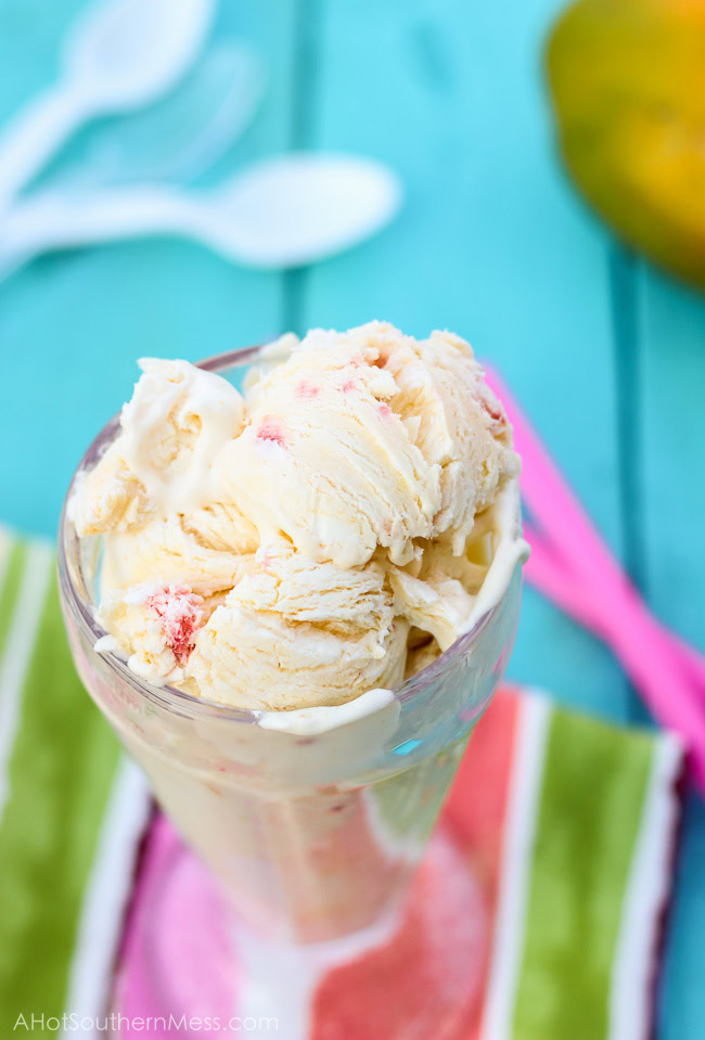 Fresh creamy strawberry mango ice cream with hand picked strawberry pieces and puréed mango folded in. Ten minutes of prep work and just a hand mixer is all that you need to prepare this light, sweet, refreshing treat for those long dog days of summer! www.ahotsouthernmess.com