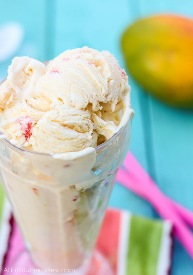 Fresh creamy strawberry mango ice cream with hand picked strawberry pieces and puréed mango folded in. Ten minutes of prep work and just a hand mixer is all that you need to prepare this light, sweet, refreshing treat for those long dog days of summer! www.ahotsouthernmess.com