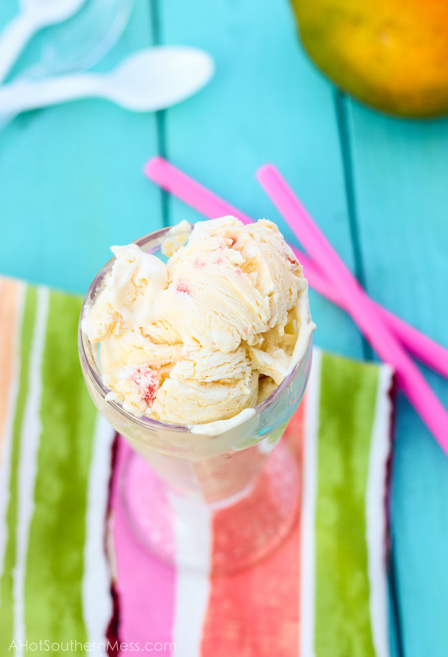 Fresh creamy strawberry mango ice cream with hand picked strawberry pieces and puréed mango folded in. Ten minutes of prep work and just a hand mixer is all that you need to prepare this light, sweet, refreshing treat for those long dog days of summer! www.ahotsouthernmess.com