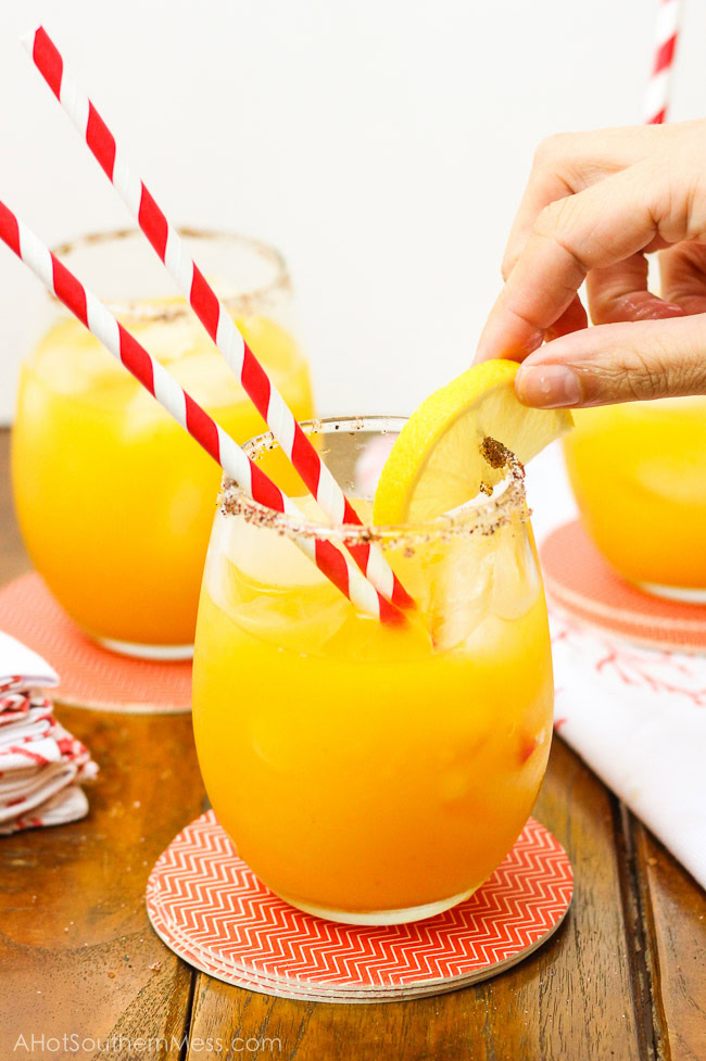 A sweet refreshing twist on summer lemonade. The fusion of mango and chili powder along with a splash of hot sauce, add a fun spicy summer twist {oh, and did I forget to mention the chili powder and sugar-laced rims? How dare me???}. And for those of us 21 or older, the addition of white rum makes this sipping cocktail a fruity delight! www.ahotsouthernmess.com