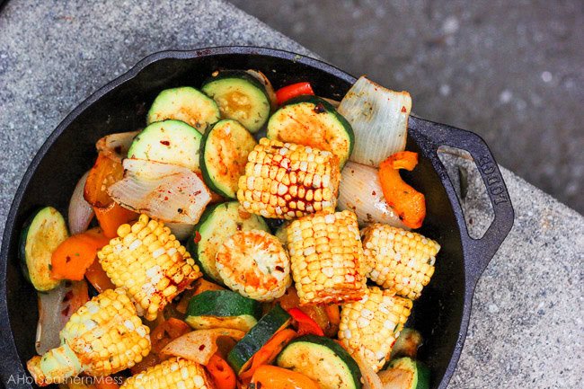 What an easy and healthy recipe! These fresh sweet veggies are placed on the grill in a cast iron skillet, drizzled with olive oil and sriracha, and then sprinkled with more fire with crushed red pepper flakes, before being toasted to perfection. The end result is sweet and spicy tender veggies with a hint of the grill and a bit of crispity crunch. www.ahotsouthernmess.com