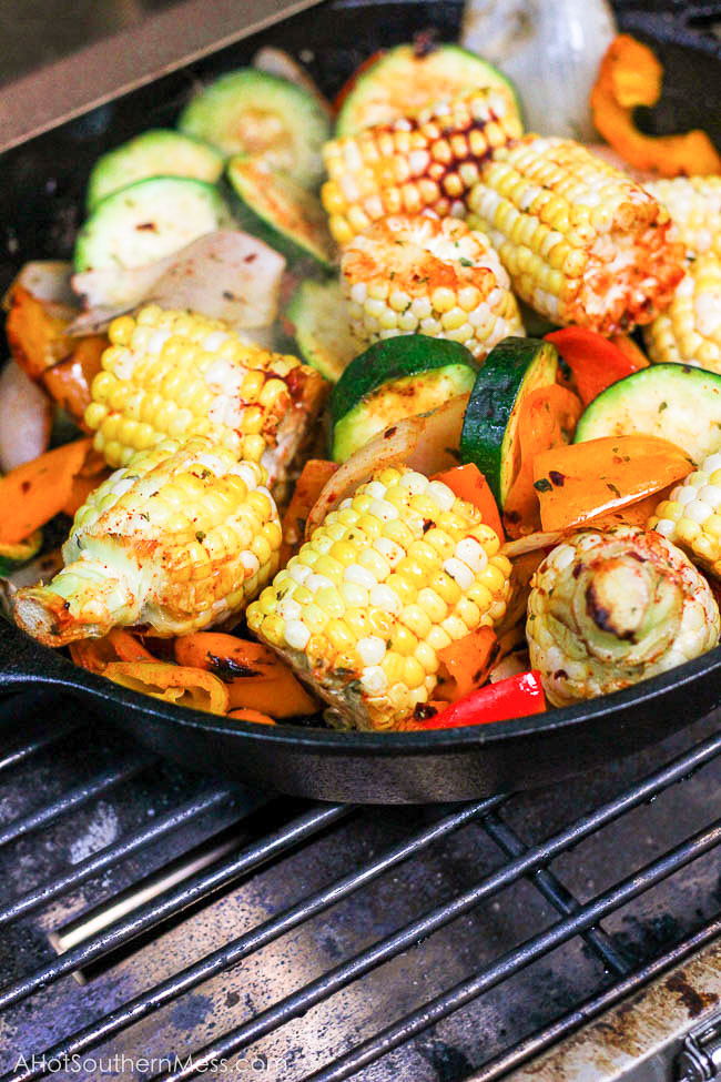 What an easy and healthy recipe! These fresh sweet veggies are placed on the grill in a cast iron skillet, drizzled with olive oil and sriracha, and then sprinkled with more fire with crushed red pepper flakes, before being toasted to perfection. The end result is sweet and spicy tender veggies with a hint of the grill and a bit of crispity crunch. www.ahotsouthernmess.com