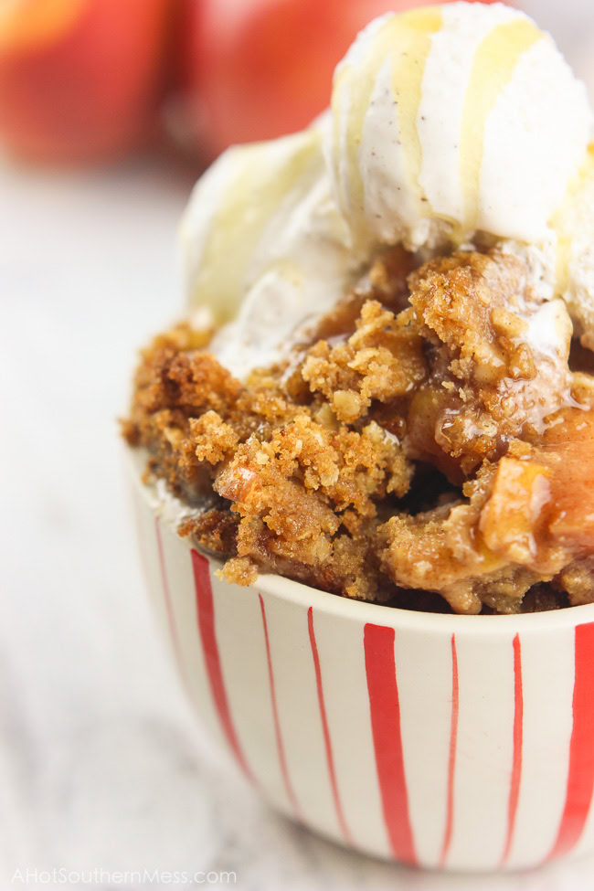 This gluten-free apple crumble is a favorite fall treat. Crisp apples are mixed with sweet end-of-season peaches as a base. Cinnamon, brown sugar, gluten-free oats, and lemon juice are combined with a bit of sweet cream butter, to finish off the candy-like crumble topping. Serve right out of the oven with soft vanilla bean ice cream and a fresh honey drizzle. www.ahotsouthernmess.com