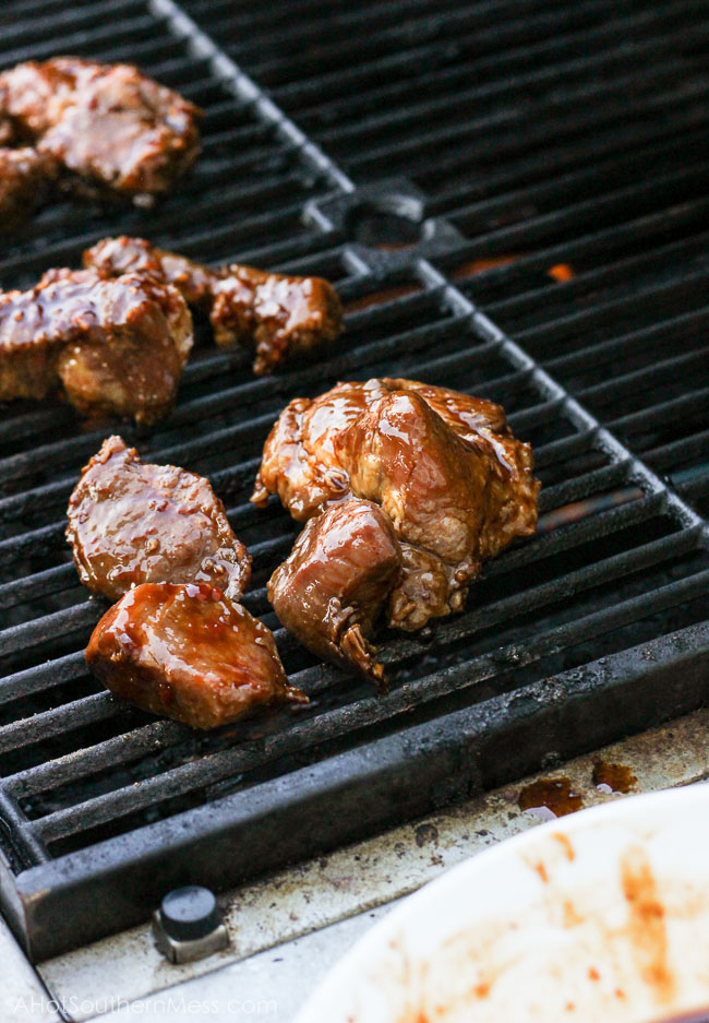 Spicy sticky asian ribs are drizzled in sweet and spicy glaze, kissed to a slight crunch on the grill, and melt-in-your-mouth, incredibly tender on the inside. These pork ribs are finger-lickin' and slap yo mama silly kind of 'good'. www.ahotsouthernmess.com