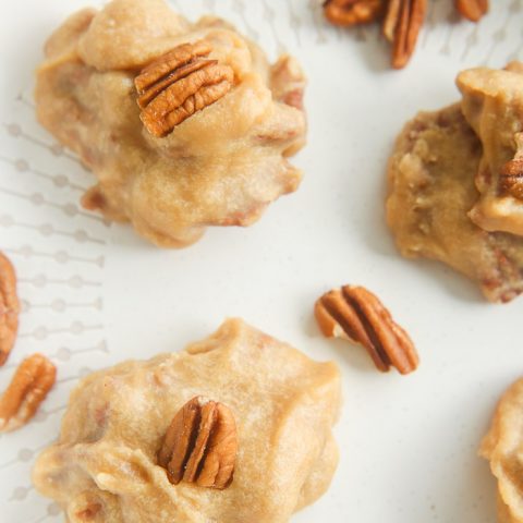 close up of pecan pralines on white dish