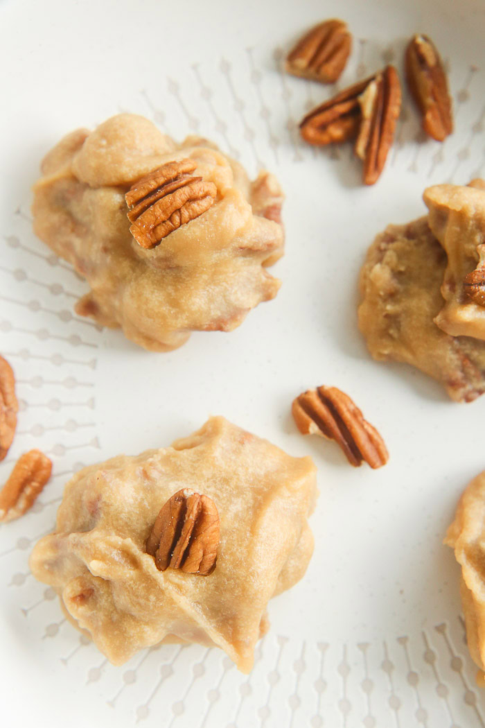 close up of pecan pralines on white dish