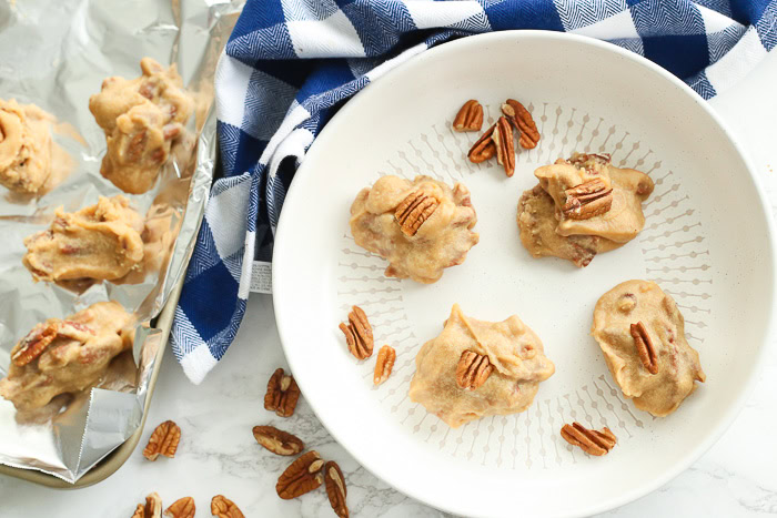 southern pecan pralines on tin foil sheet and white bowl