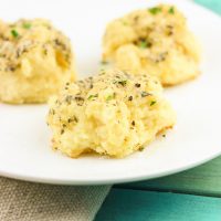 Soft gooey rolls that are topped with a fresh garlic butter sauce then sprinkled with parmesan and coarse sea salt and then smothered in garlic butter once again. These gluten-free bites are a quick and easy game-changer for any meal that they are served with! www.blessherheartyall.com