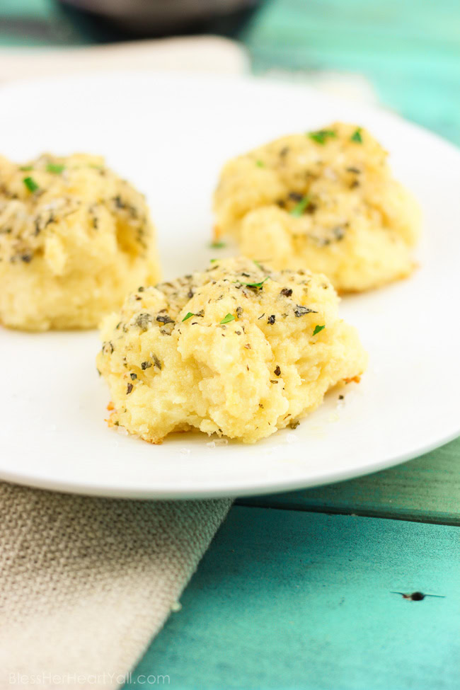 Soft gooey rolls that are topped with a fresh garlic butter sauce then sprinkled with parmesan and coarse sea salt and then smothered in garlic butter once again. These gluten-free bites are a quick and easy game-changer for any meal that they are served with! www.blessherheartyall.com