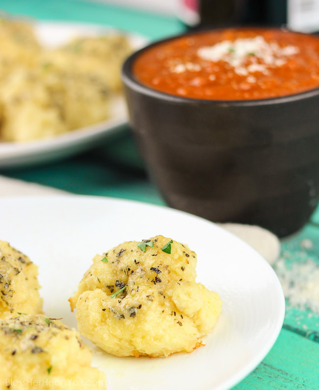 Soft gooey rolls that are topped with a fresh garlic butter sauce then sprinkled with parmesan and coarse sea salt and then smothered in garlic butter once again. These gluten-free bites are a quick and easy game-changer for any meal that they are served with! www.blessherheartyall.com