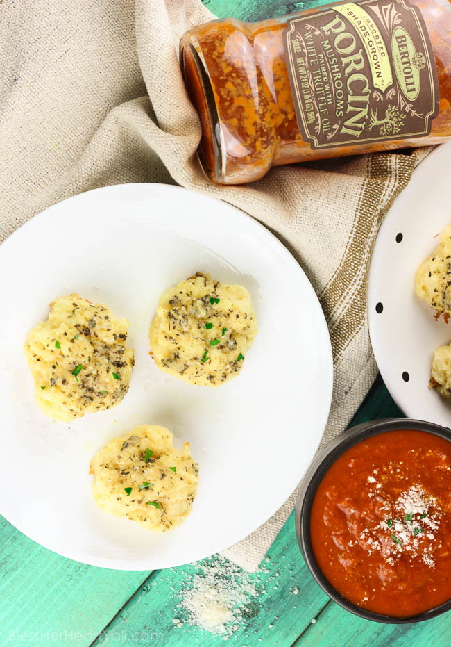 Soft gooey rolls that are topped with a fresh garlic butter sauce then sprinkled with parmesan and coarse sea salt and then smothered in garlic butter once again. These gluten-free bites are a quick and easy game-changer for any meal that they are served with! www.blessherheartyall.com