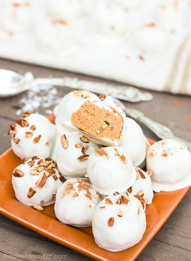 These pumpkin pecan truffles have smooth creamy pumpkin centers with pecan pieces hidden inside. The white chocolate coating is drizzled overtop and more pecan pieces sprinkled for the finale. Perfect no-bake party treats that can be quickly made! www.blessherheartyall.com