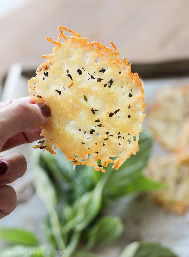 Garlic basil parmesan crisps are an easy 3 ingredient baked recipe! These great dippers are perfect appetizers or snacks for any gluten-free or low carb eaters and are huge hits at parties! All you need is parmesan, basil, garlic powder and 5 minutes beside your oven! www.blessherheartyall.com