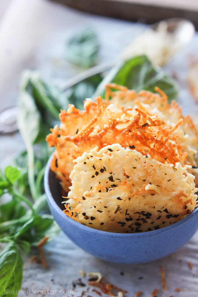 Garlic basil parmesan crisps are an easy 3 ingredient baked recipe! These great dippers are perfect appetizers or snacks for any gluten-free or low carb eaters and are huge hits at parties! All you need is parmesan, basil, garlic powder and 5 minutes beside your oven! www.blessherheartyall.com