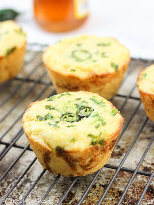 These gluten-free jalapeno cheddar cornbread cupcakes are very quick and easy to put together. The jalapeno adds some spice, the cheddar some heartiness, and the honey drizzle some sweet to finish it off. A delicious side dish to any meal that needs to warm you up and keep your belly happy. www.ahotsouthernmess.com