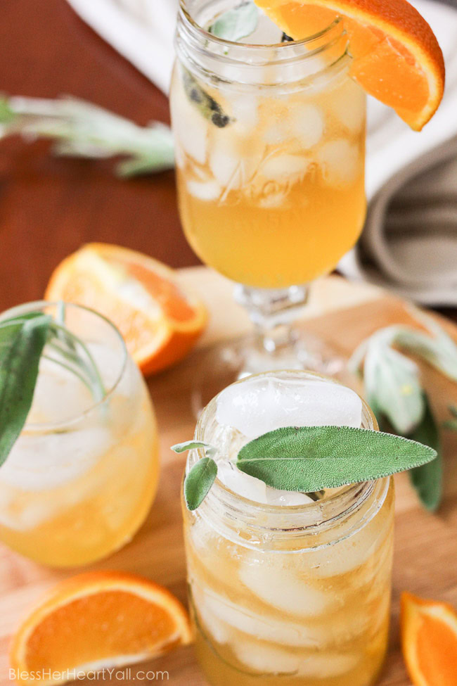 This honey bear cocktail is the perfect cocktail to sip on during those chilly fall evenings with friends on your porch or for entertaining those guests as they walk in the front door of your Thanksgiving day festivities. Made with a simple syrup of honey, sage, and orange, then combined with southern bourbon over ice, you will be sipping on a fresh, mellow, slightly sweet cocktail that everyone {including those honey bears!} will find perfect all fall long. www.blessherheartyall.com