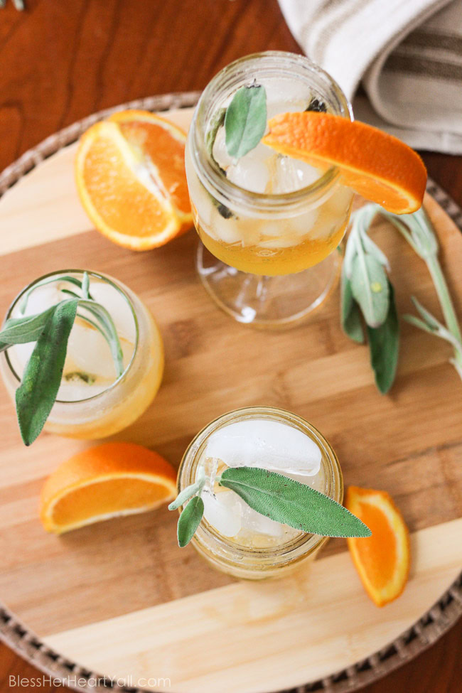 This honey bear cocktail is the perfect cocktail to sip on during those chilly fall evenings with friends on your porch or for entertaining those guests as they walk in the front door of your Thanksgiving day festivities. Made with a simple syrup of honey, sage, and orange, then combined with southern bourbon over ice, you will be sipping on a fresh, mellow, slightly sweet cocktail that everyone {including those honey bears!} will find perfect all fall long. www.blessherheartyall.com