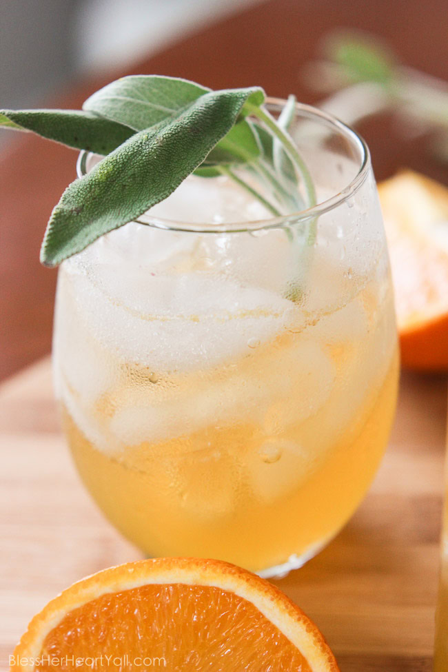 This honey bear cocktail is the perfect cocktail to sip on during those chilly fall evenings with friends on your porch or for entertaining those guests as they walk in the front door of your Thanksgiving day festivities. Made with a simple syrup of honey, sage, and orange, then combined with southern bourbon over ice, you will be sipping on a fresh, mellow, slightly sweet cocktail that everyone {including those honey bears!} will find perfect all fall long. www.blessherheartyall.com