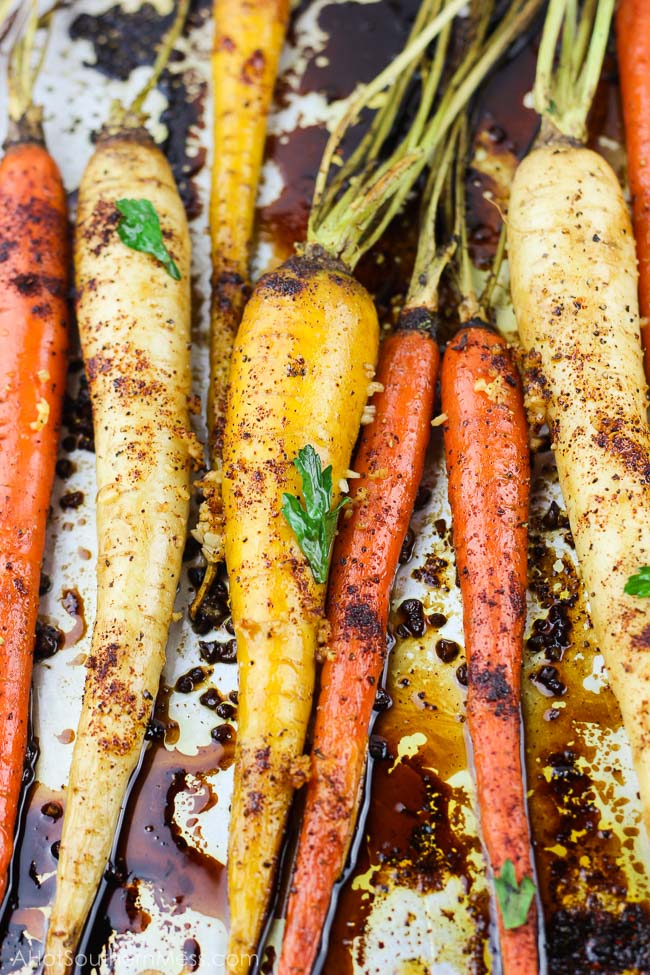 With 5 minutes of prep work and a couple of simple ingredients, these spicy honey garlic roasted carrots are an easy gluten-free fall side dish that is both full of flavor and healthy. With the combination of chili powder, garlic, and honey, with an easy balsamic glaze drizzle, you have both a sweet and spicy, tender yet crunchy vegetable for your table spread. www.ahotsouthernmess.com