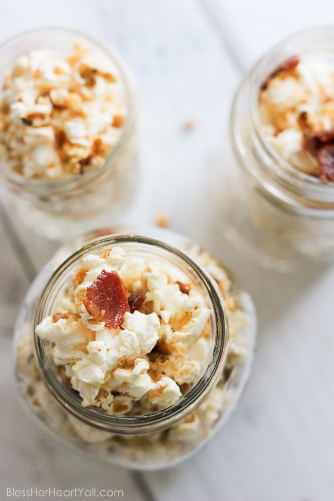 This maple, bacon, bourbon popcorn hits all the right spots, with it's freshly popped popcorn, sprinkled with thick-cut applewood bacon, and then drizzled with butter, salt, maple syrup, and of course bourbon! It's a quick, easy, and inexpensive DIY gift for friends, co-workers, and host/hostess's this holiday season! www.blessherheartyall.com DIY Hostess Gift: Maple, Bacon, Bourbon Popcorn