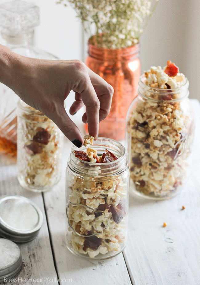 This maple, bacon, bourbon popcorn hits all the right spots, with it's freshly popped popcorn, sprinkled with thick-cut applewood bacon, and then drizzled with butter, salt, maple syrup, and of course bourbon! It's a quick, easy, and inexpensive DIY gift for friends, co-workers, and host/hostess's this holiday season! www.blessherheartyall.com DIY Hostess Gift: Maple, Bacon, Bourbon Popcorn